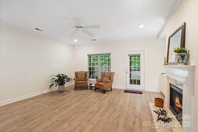608 Camrose Cir NE, Concord, NC 28025 - sitting room with crown molding, light wood finished floors, a high end fireplace, recessed lighting, and a ceiling fan