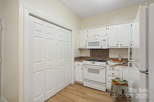 608 Camrose Cir NE, Concord, NC 28025 - kitchen with white appliances, white cabinets, dark countertops, and light wood-type flooring