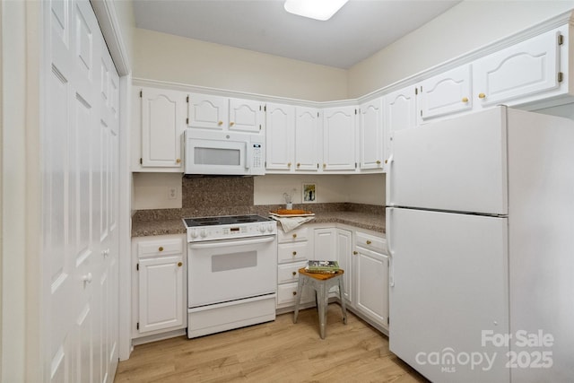 608 Camrose Cir NE, Concord, NC 28025 - kitchen with white appliances, white cabinetry, light wood-style floors, and dark countertops