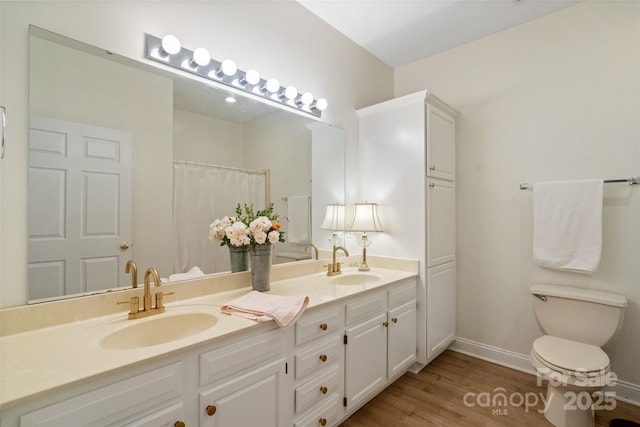 608 Camrose Cir NE, Concord, NC 28025 - bathroom with double vanity and wood finished floors