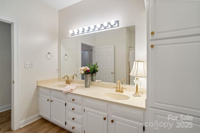 608 Camrose Cir NE, Concord, NC 28025 - bathroom with double vanity and wood finished floors