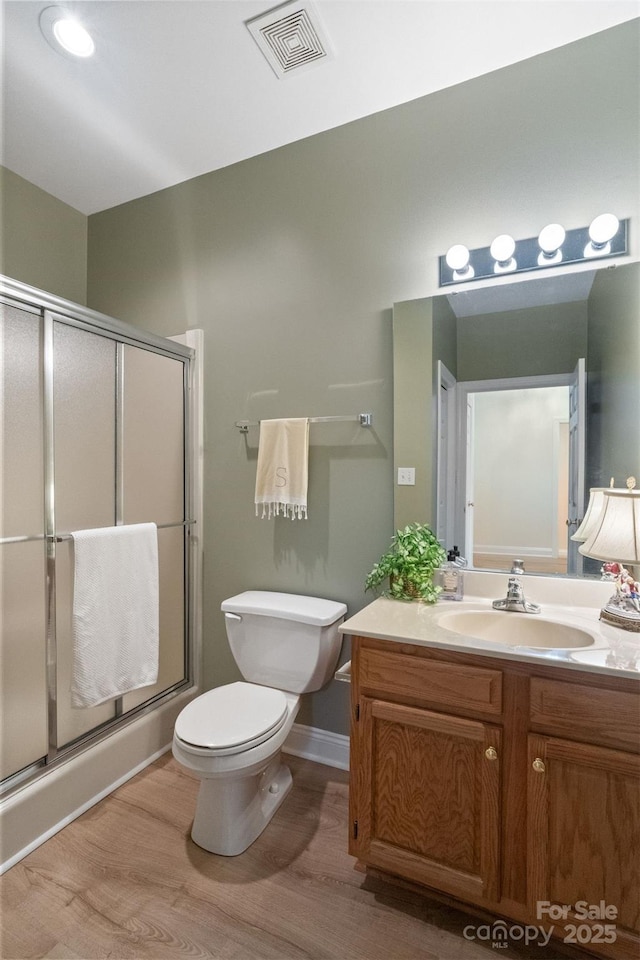 608 Camrose Cir NE, Concord, NC 28025 - bathroom with vanity, wood finished floors, and a stall shower