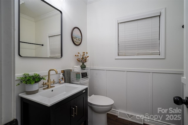 1575 Lewis Farm Rd, Kings Mountain, NC 28086 - bathroom featuring ornamental molding, vanity, a decorative wall, toilet, and wood finished floors