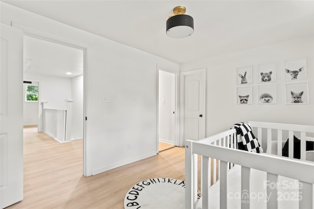 815 E Second Ave, Gastonia, NC 28054 - bedroom with light wood-style flooring and a crib