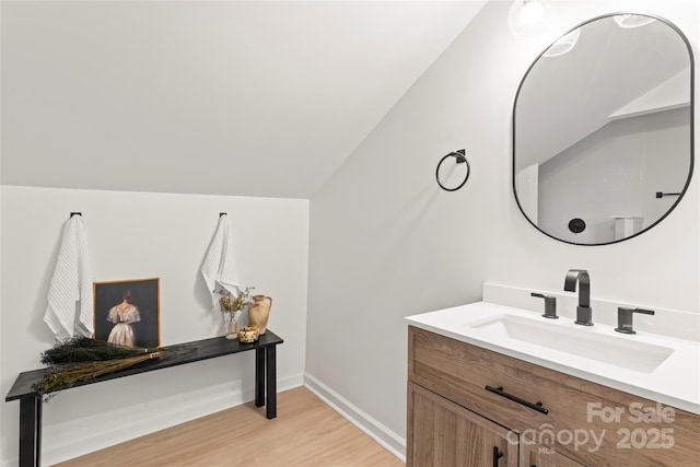 815 E Second Ave, Gastonia, NC 28054 - bathroom featuring wood finished floors, vanity, and lofted ceiling