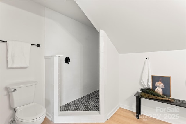 815 E Second Ave, Gastonia, NC 28054 - full bathroom with a tile shower, vaulted ceiling, and wood finished floors