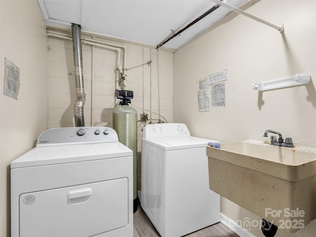 65 Brookside Dr Unit 35, Hendersonville, NC 28792 - washroom with a sink, washer and dryer, and light wood-style flooring