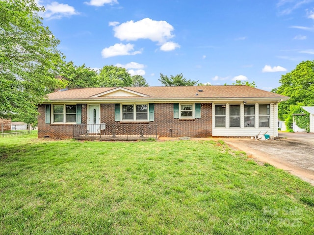 view of front of property with brick siding and a front yard