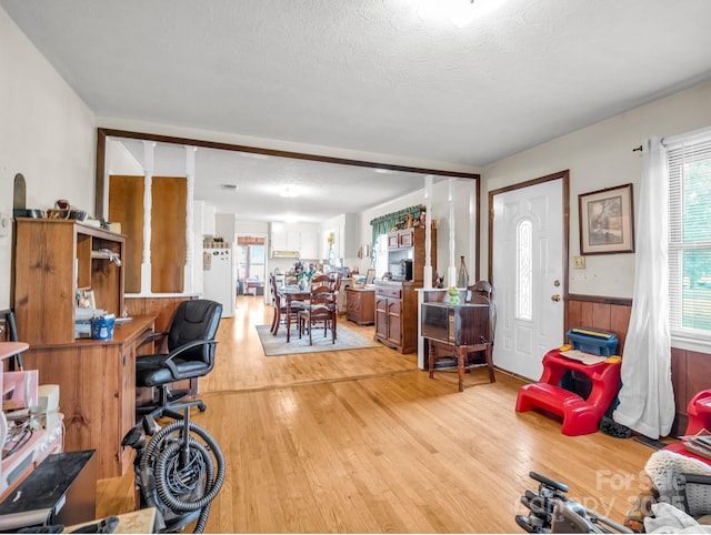 office space with wood finished floors, wainscoting, and a textured ceiling