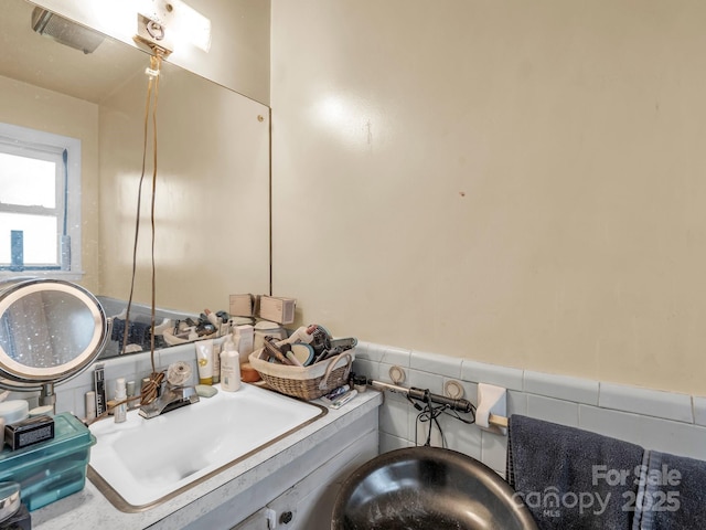 bathroom with a sink and a wainscoted wall