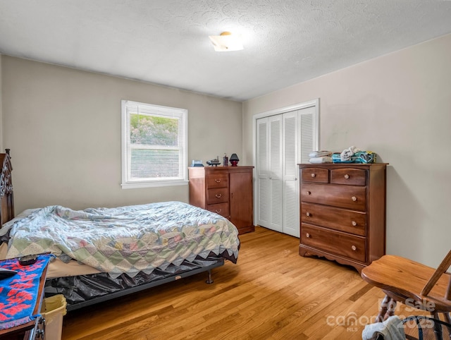 bedroom with light wood-style flooring and a closet