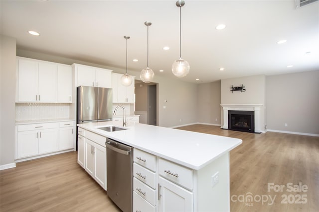 256 W Waterlynn Rd, Mooresville, NC 28117 - kitchen with appliances with stainless steel finishes, a sink, recessed lighting, backsplash, and baseboards