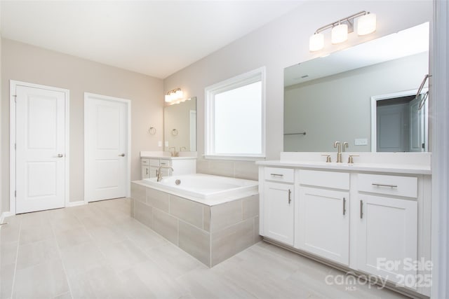256 W Waterlynn Rd, Mooresville, NC 28117 - bathroom with tile patterned floors, a bath, and two vanities