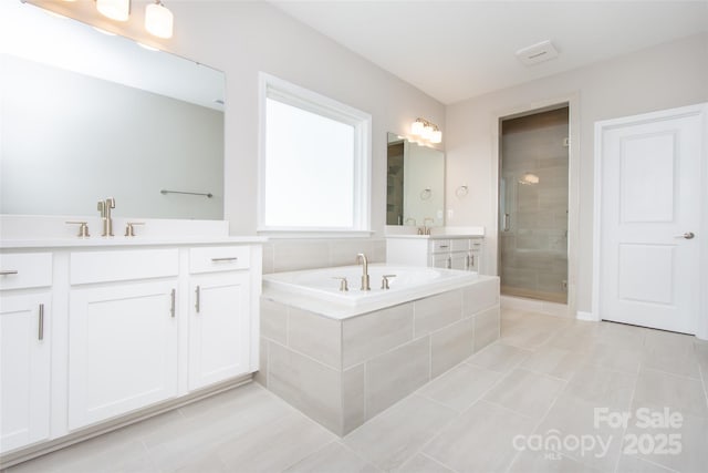 256 W Waterlynn Rd, Mooresville, NC 28117 - full bath featuring tile patterned flooring, a stall shower, two vanities, and a bath