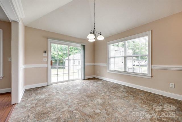 2027 Ellison Dr, Rock Hill, SC 29730 - spare room featuring plenty of natural light, a chandelier, stone finish floors, and lofted ceiling