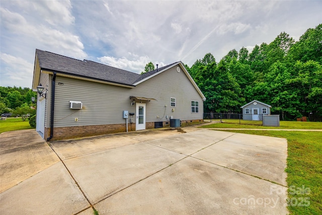 2027 Ellison Dr, Rock Hill, SC 29730 - view of side of property featuring an outbuilding, a patio, concrete driveway, a wall mounted air conditioner, and roof with shingles