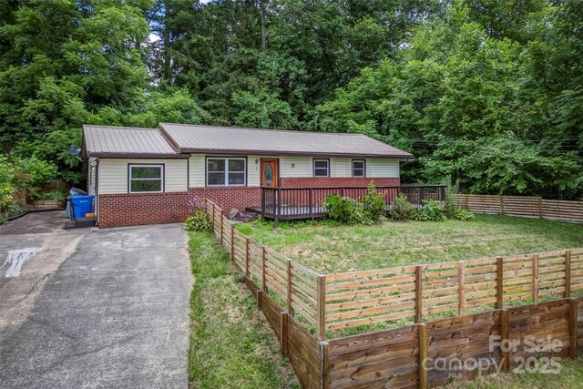 ranch-style home with brick siding and a wooden deck