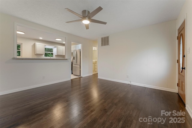 unfurnished living room with a ceiling fan, dark wood-style flooring, and baseboards