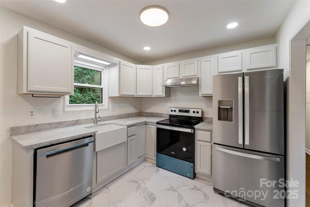 kitchen with appliances with stainless steel finishes, light marble finish floors, recessed lighting, a sink, and white cabinets