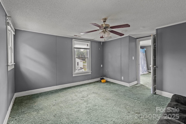 unfurnished bedroom with carpet, a textured ceiling, baseboards, and a ceiling fan