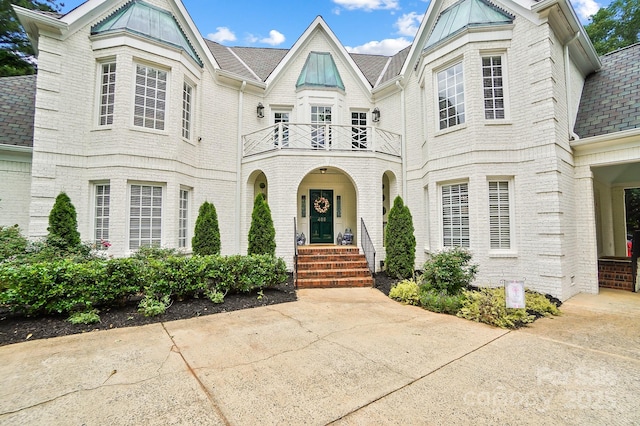 469 Valley Run Dr, Waxhaw, NC 28173 - view of front of home featuring a balcony, a shingled roof, and brick siding