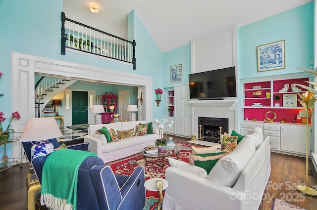 469 Valley Run Dr, Waxhaw, NC 28173 - living room featuring high vaulted ceiling, stairway, a premium fireplace, and dark wood finished floors
