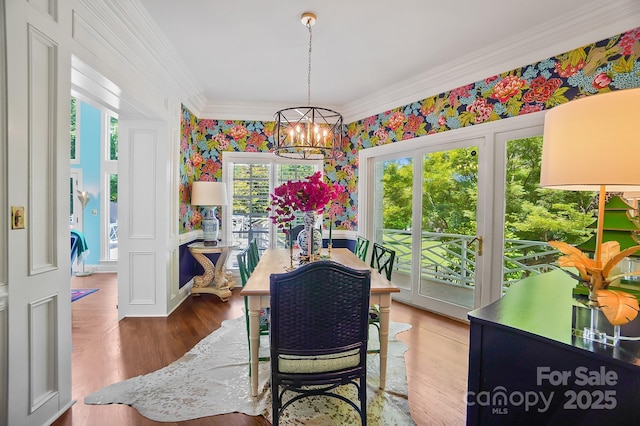 469 Valley Run Dr, Waxhaw, NC 28173 - dining room featuring a chandelier, ornamental molding, wallpapered walls, and wood finished floors