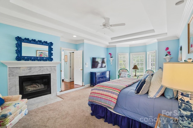 469 Valley Run Dr, Waxhaw, NC 28173 - carpeted bedroom featuring a raised ceiling, recessed lighting, a high end fireplace, a ceiling fan, and crown molding