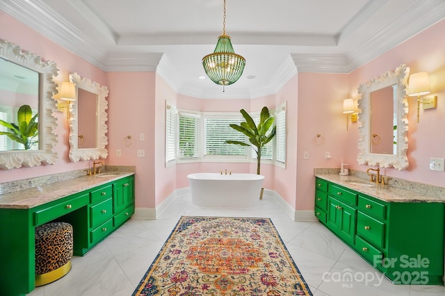 469 Valley Run Dr, Waxhaw, NC 28173 - bathroom featuring a chandelier, a freestanding bath, crown molding, two vanities, and baseboards