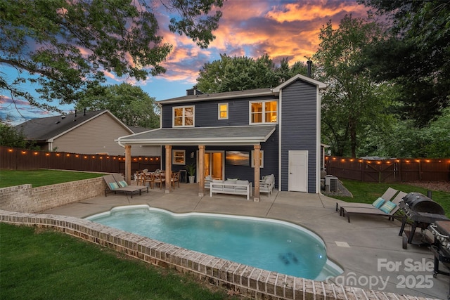 8007 Maxwelton Dr, Huntersville, NC 28078 - back of property at dusk with an outdoor hangout area, a chimney, and a patio