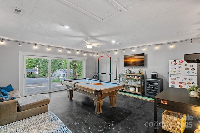 8007 Maxwelton Dr, Huntersville, NC 28078 - recreation room featuring rail lighting, wine cooler, finished concrete flooring, a textured ceiling, and a ceiling fan