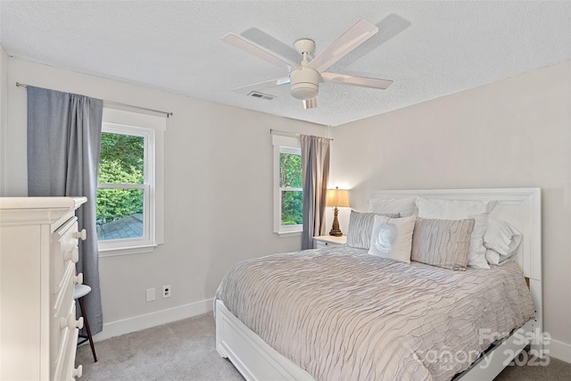 8007 Maxwelton Dr, Huntersville, NC 28078 - bedroom with multiple windows, light colored carpet, baseboards, a textured ceiling, and a ceiling fan