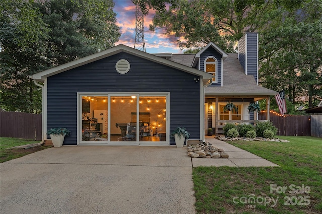 8007 Maxwelton Dr, Huntersville, NC 28078 - back of house at dusk featuring a chimney and a porch