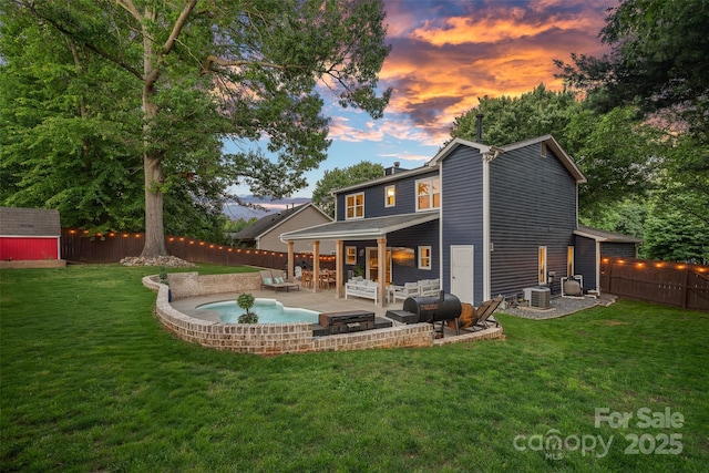 8007 Maxwelton Dr, Huntersville, NC 28078 - back of property at dusk featuring a patio, a chimney, central AC, and an outdoor hangout area
