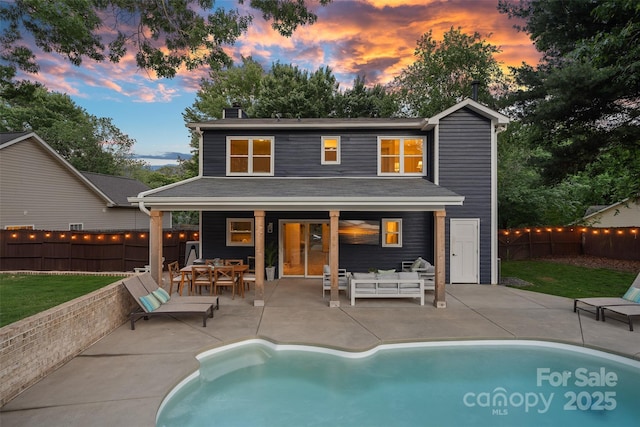 8007 Maxwelton Dr, Huntersville, NC 28078 - back of property at dusk featuring a chimney, a patio area, an outdoor living space, and outdoor dining area