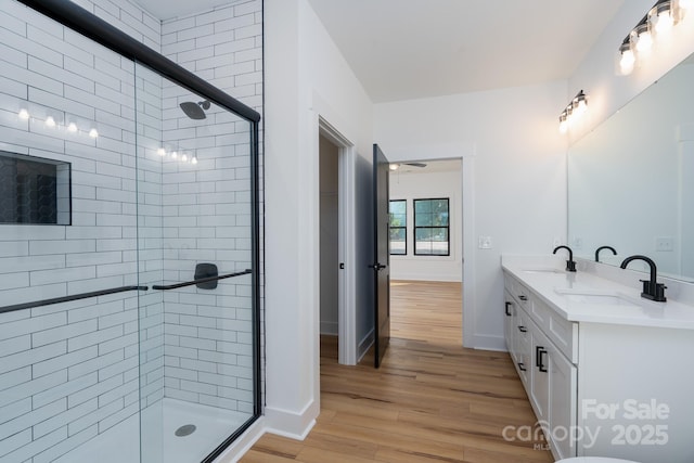 315 W Hoke St W, Landis, NC 28088 - full bath featuring wood finished floors, a shower stall, double vanity, and baseboards