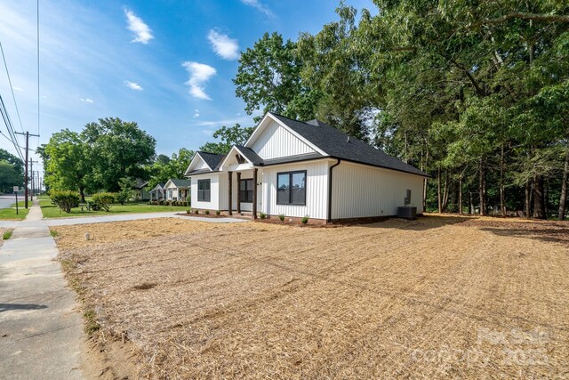 315 W Hoke St W, Landis, NC 28088 - modern farmhouse featuring board and batten siding, central air condition unit, and a shingled roof