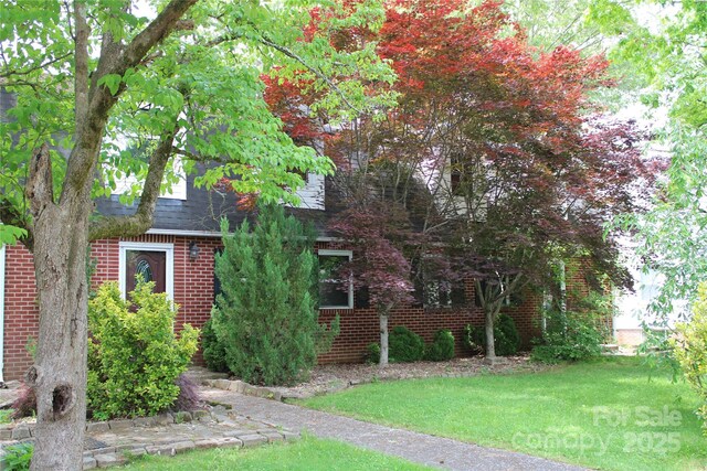 426/432 Maple St, Brevard, NC 28712 - obstructed view of property featuring brick siding, a shingled roof, and a front yard