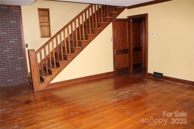 426/432 Maple St, Brevard, NC 28712 - unfurnished living room featuring stairway, wood-type flooring, and baseboards
