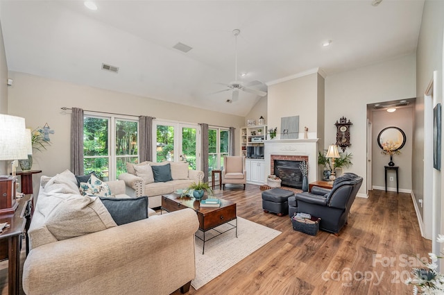 5208 Black Oak Ln, Waxhaw, NC 28173 - living room featuring a ceiling fan, wood finished floors, a fireplace, baseboards, and high vaulted ceiling