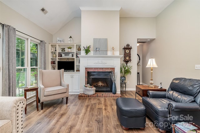 5208 Black Oak Ln, Waxhaw, NC 28173 - living room with wood finished floors, a fireplace, and lofted ceiling