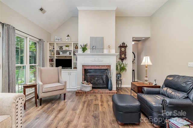 5208 Black Oak Ln, Waxhaw, NC 28173 - living area featuring wood finished floors, a fireplace, lofted ceiling, and baseboards