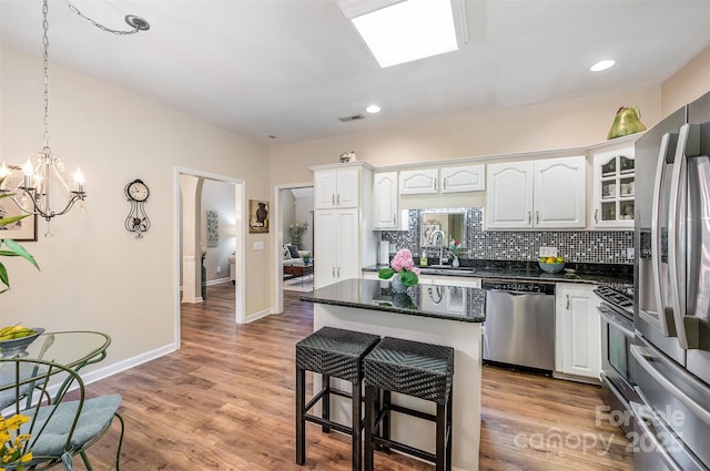 5208 Black Oak Ln, Waxhaw, NC 28173 - kitchen featuring stainless steel appliances, white cabinets, a sink, a kitchen island, and recessed lighting