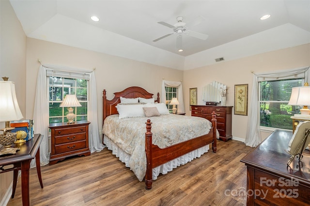 5208 Black Oak Ln, Waxhaw, NC 28173 - bedroom with wood finished floors, multiple windows, a ceiling fan, recessed lighting, and a tray ceiling