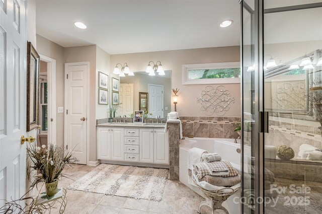 5208 Black Oak Ln, Waxhaw, NC 28173 - bathroom with double vanity, a garden tub, tile patterned floors, a stall shower, and recessed lighting
