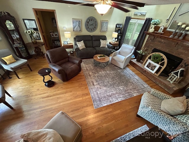 2815 Penny Park Dr, Gastonia, NC 28052 - living room featuring wood finished floors, a ceiling fan, and a brick fireplace