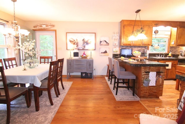 2815 Penny Park Dr, Gastonia, NC 28052 - dining area with healthy amount of natural light, light wood-style floors, and a chandelier