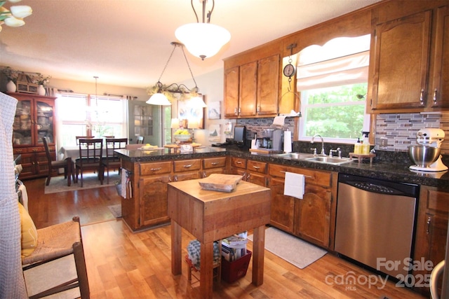 2815 Penny Park Dr, Gastonia, NC 28052 - kitchen featuring stainless steel dishwasher, a sink, a peninsula, and plenty of natural light