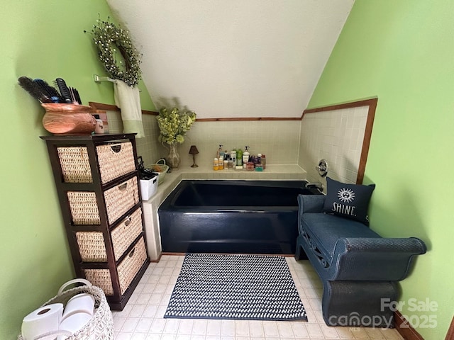2815 Penny Park Dr, Gastonia, NC 28052 - bathroom with vaulted ceiling, a bath, and tile patterned floors