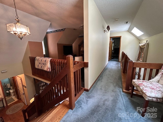 2815 Penny Park Dr, Gastonia, NC 28052 - hallway with an upstairs landing, vaulted ceiling, a textured ceiling, carpet flooring, and a chandelier